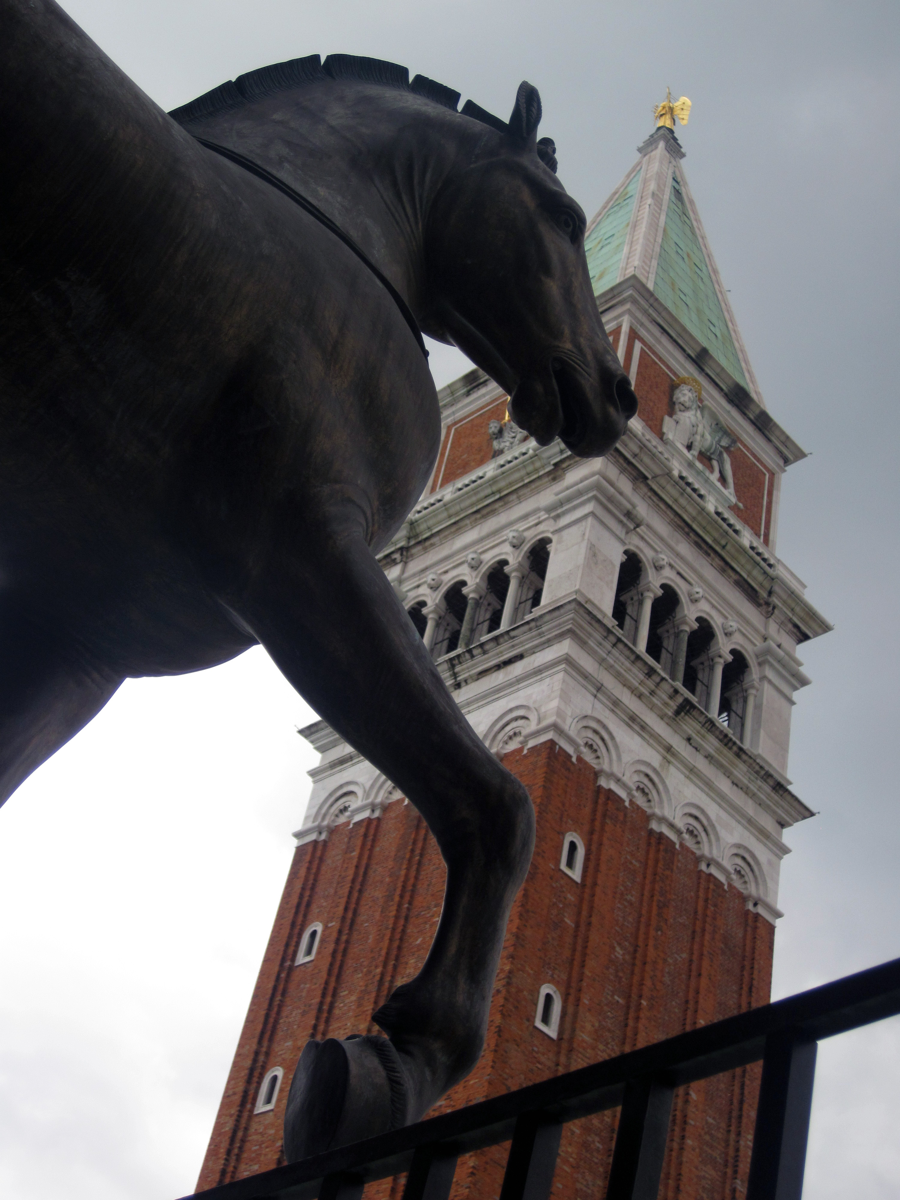 Uno de los caballos de San Marcos mira atento hacia la plaza. De fondo, el campanario.